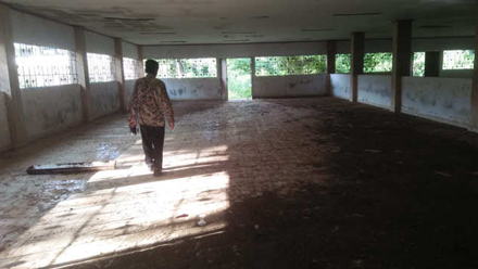 3D rendering of modern high-rise building with glass façade and complex geometric shapes